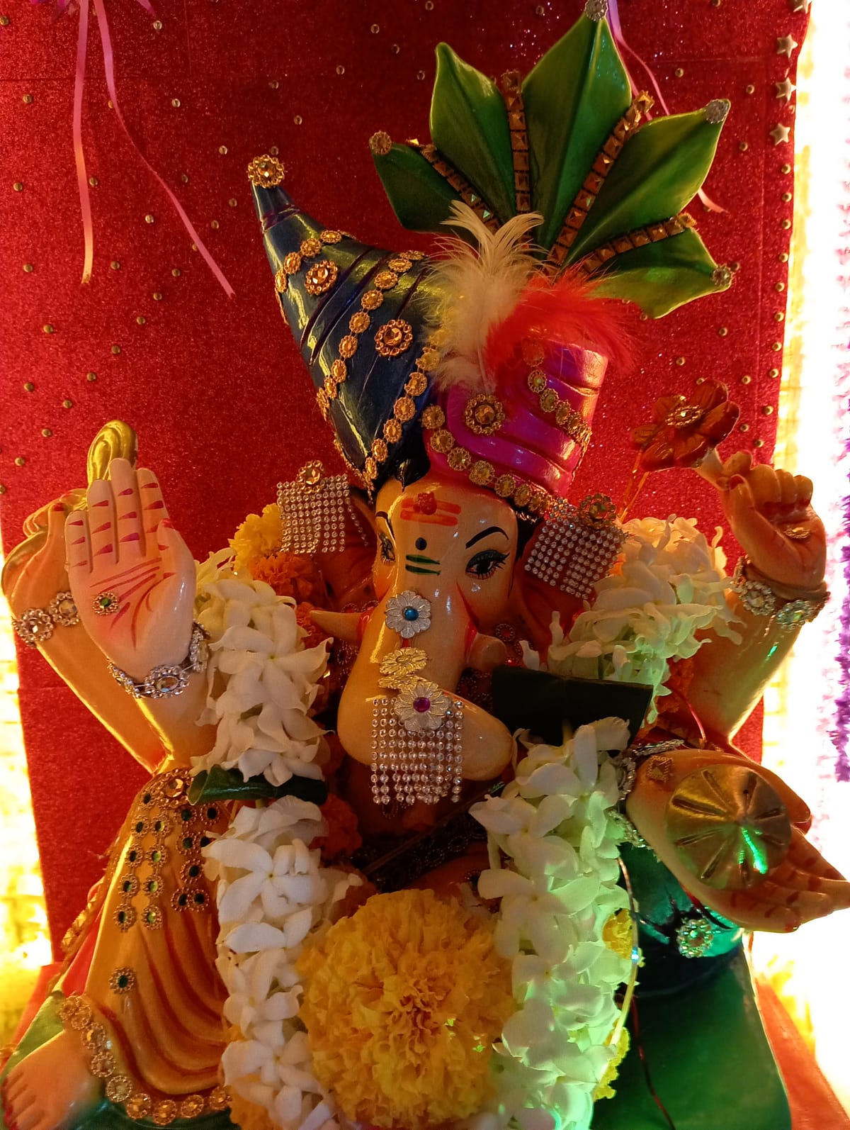 Ganesh Chaturthi idol adorned with flowers and jewels
