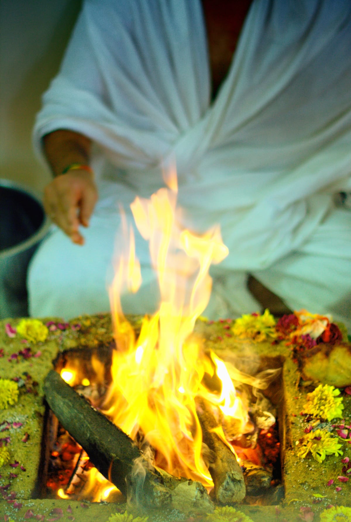 A pandit offering ghee into the sacred fire during a havan